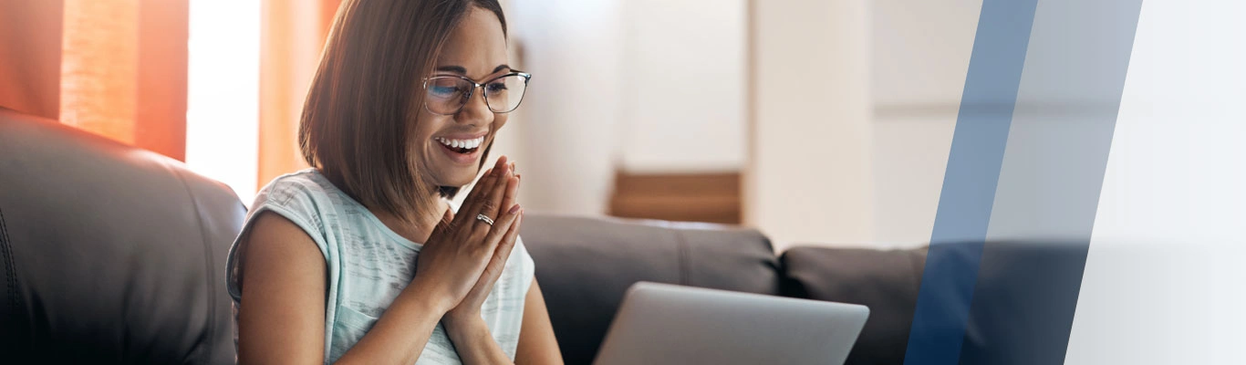 Smiling woman looking at laptop