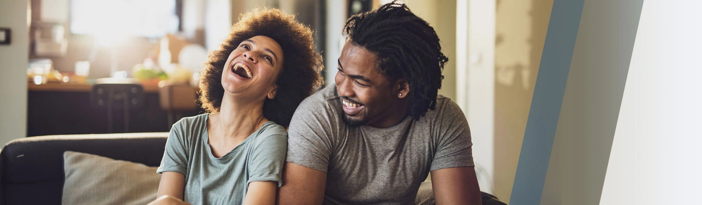 Laughing couple in living room