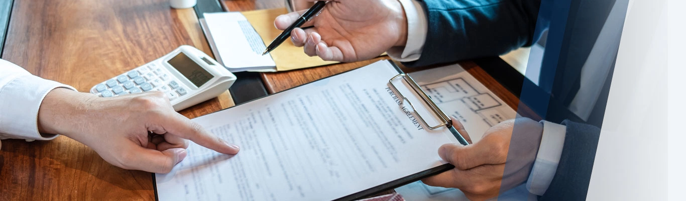 close up image of hands going over mortgage documents