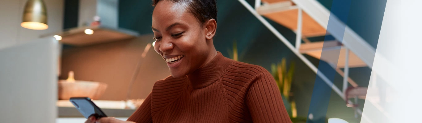 Smiling woman with laptop and mobile phone