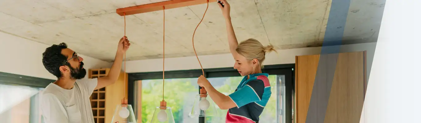 Couple installing lights in their home. 