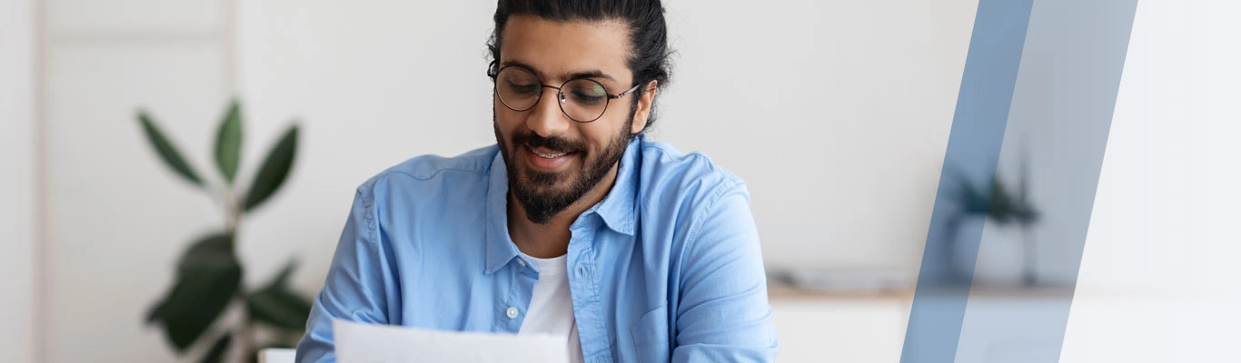 Smiling man reading documents