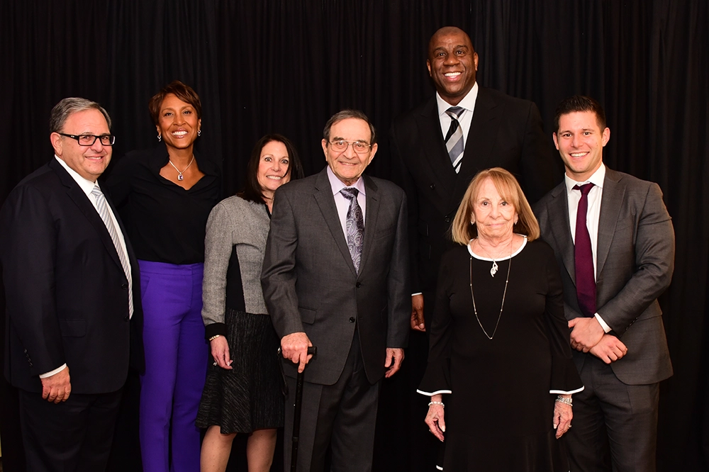 Stan, Roslyn, Lenny, Ronnie, and Michael with Robin Roberts, former anchor for ABC's Good Morning America, and Earvin "Magic" Johnson, Jr.