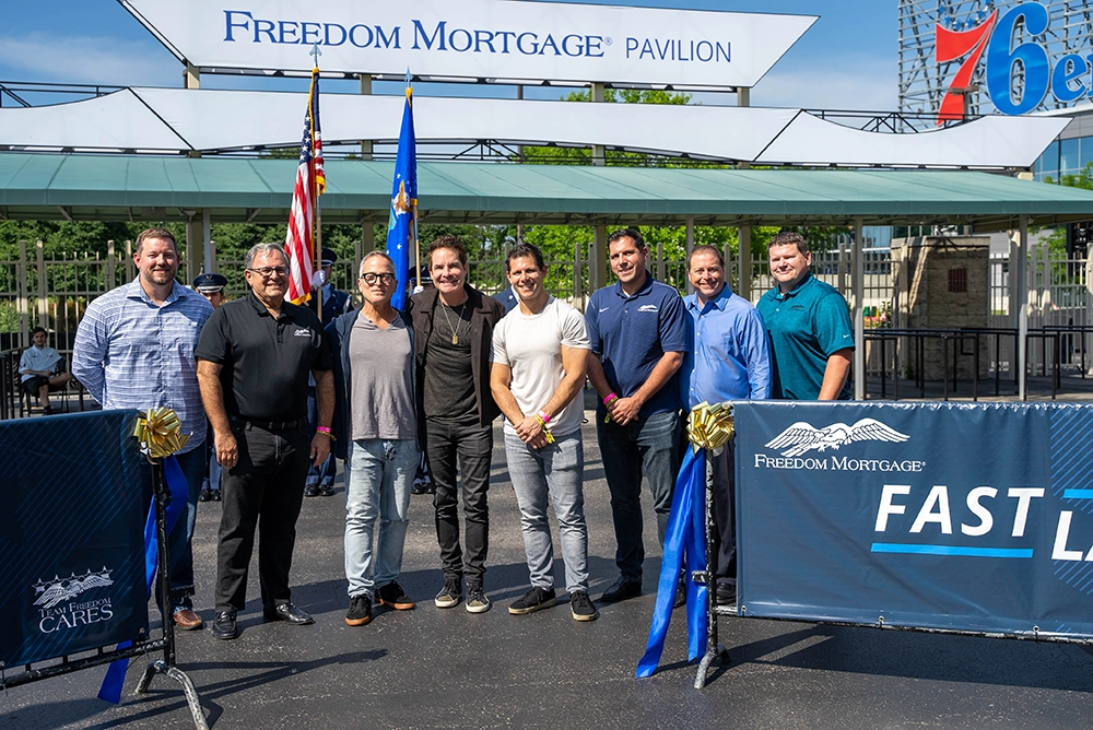 Stan with his two sons, Michael and Greg, alongside Freedom Mortgage Executives David Sheeler and Mike Patterson, Live Nation Executives Geoff Gordon and Chris Collins, and the lead singer of Train, Pat Monahan