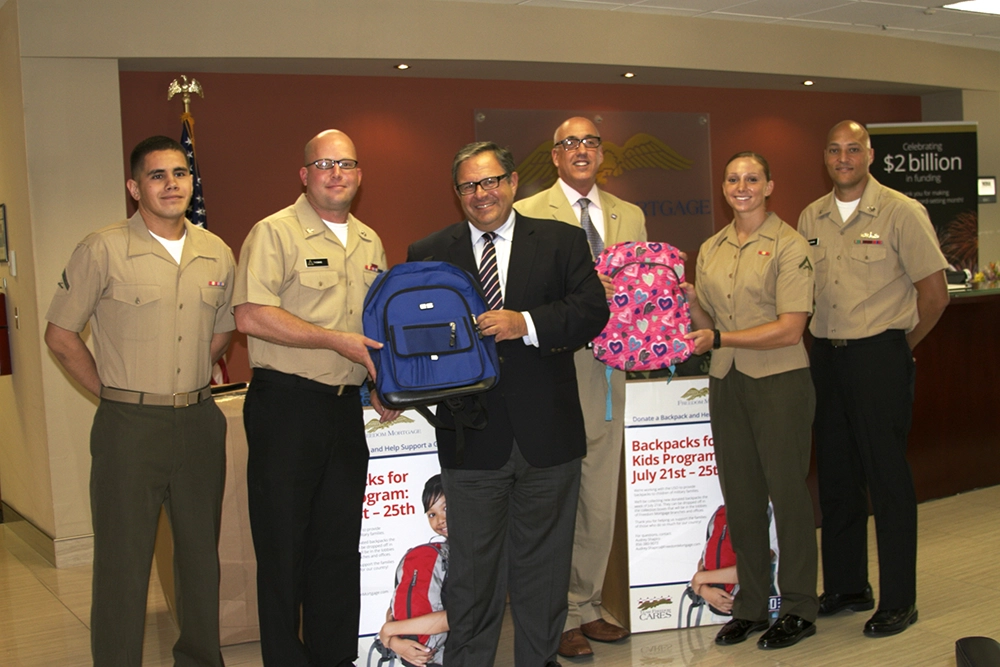 Stan at a Rucksacks to Backpacks distribution event with a few members of the Marine Corps in 2014