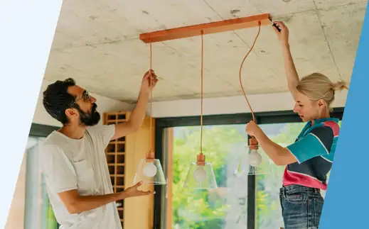 Couple installing lights in their home. 