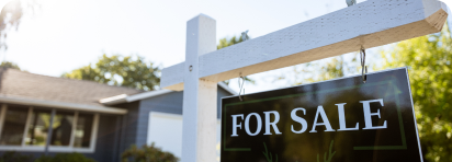 photo of family with home cardboard lifted above