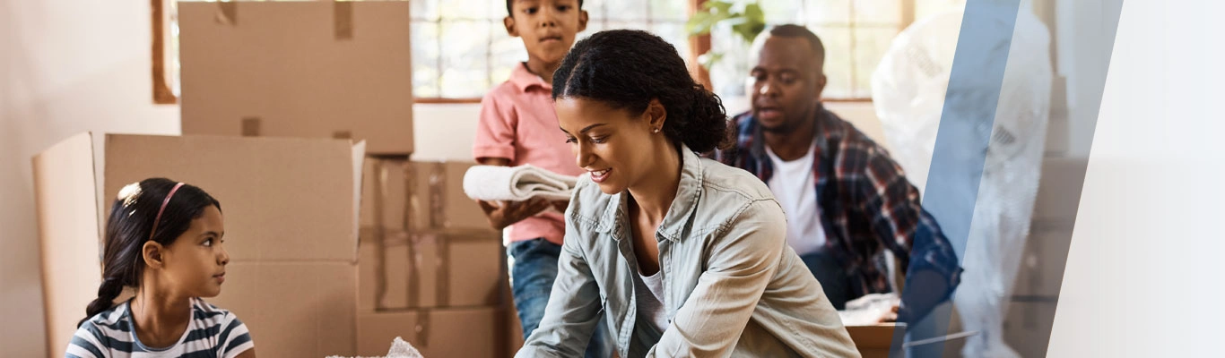 Family unpacking boxes in new home