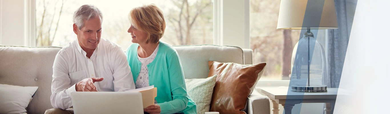 Retired couple with laptop and documents