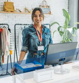 Smiling woman inside her clothing shop